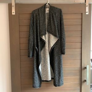 Long, dark grey sweater with dual pockets and fun neck line. Size L